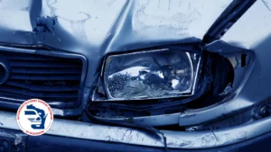 Front of car with damage and smashed headlight with AASN logo in bottom right.